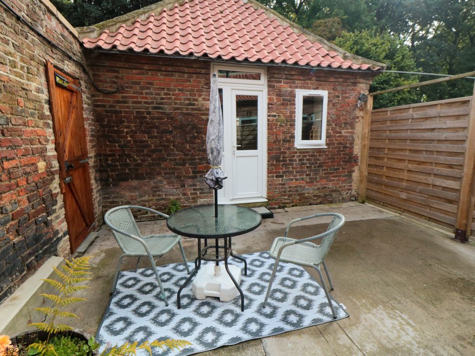 An outdoor area with a table and chairs at The Guest Room in Redcar