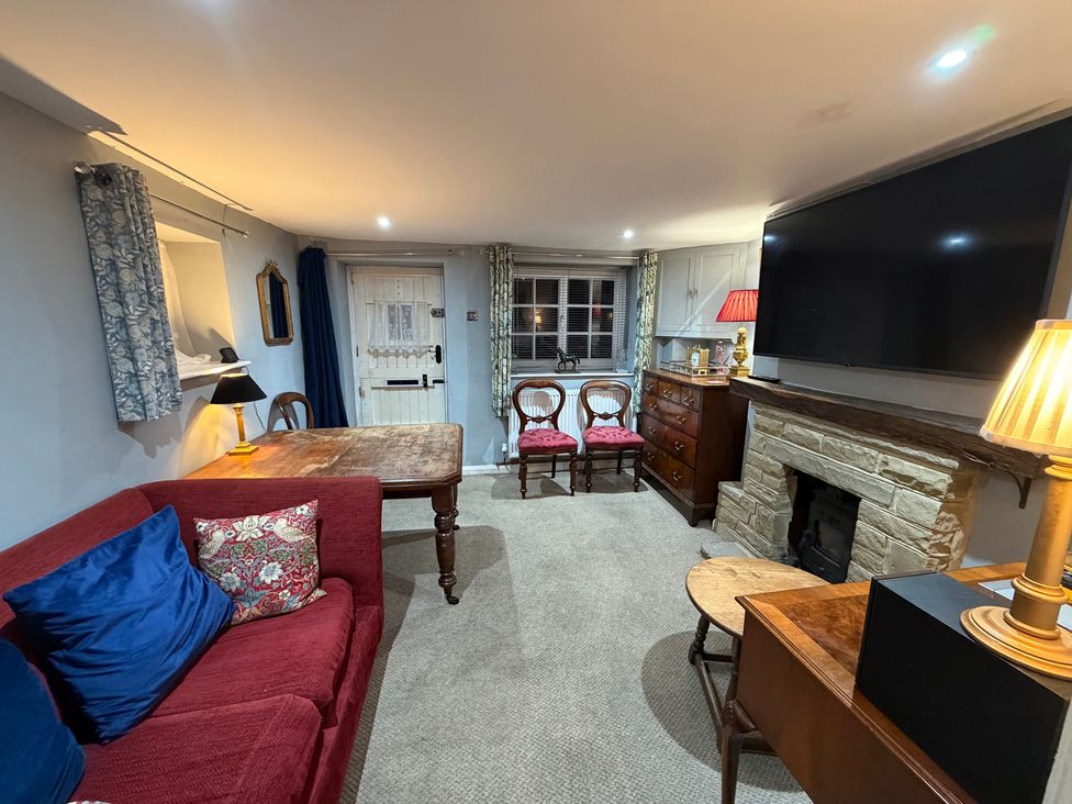 A living room with a sofa and a coffee table at Rose Cottage in Brighton and Hove