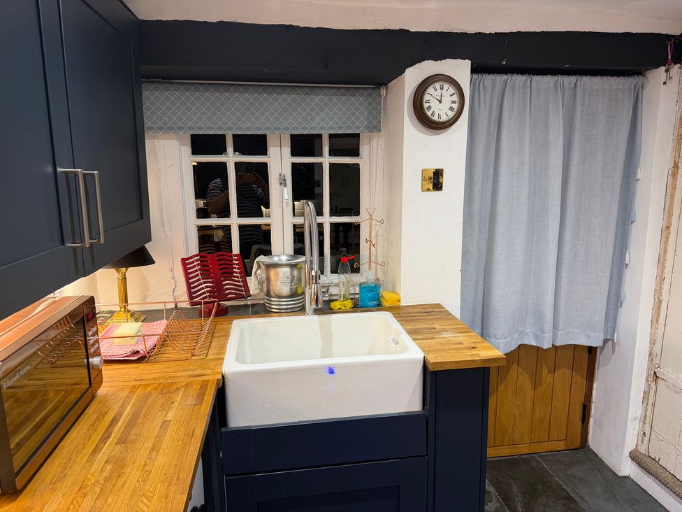 A kitchen with a sink and cabinets at Rose Cottage in Brighton and Hove