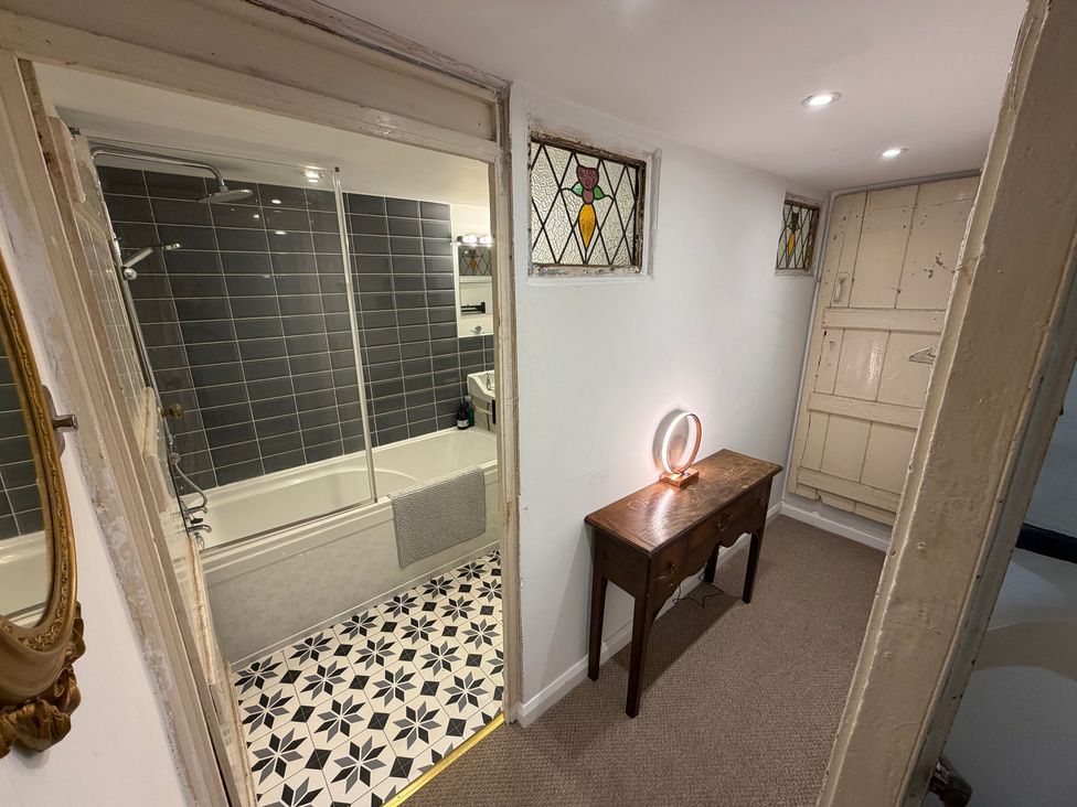 A bathroom featuring a bathtub and shower at Rose Cottage in Brighton and Hove