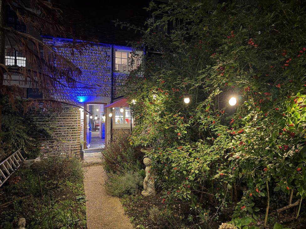 A garden with a path and lights at Rose Cottage in Brighton and Hove