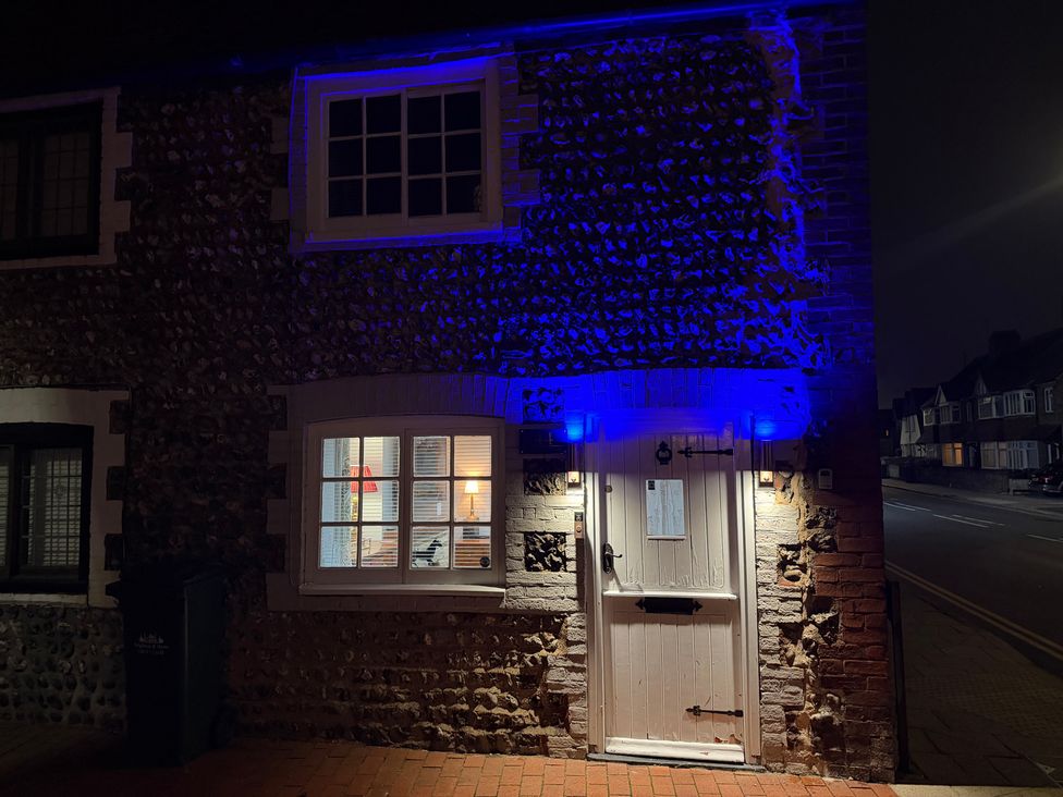 A doorway with a window and blue lights at Rose Cottage in Brighton and Hove
