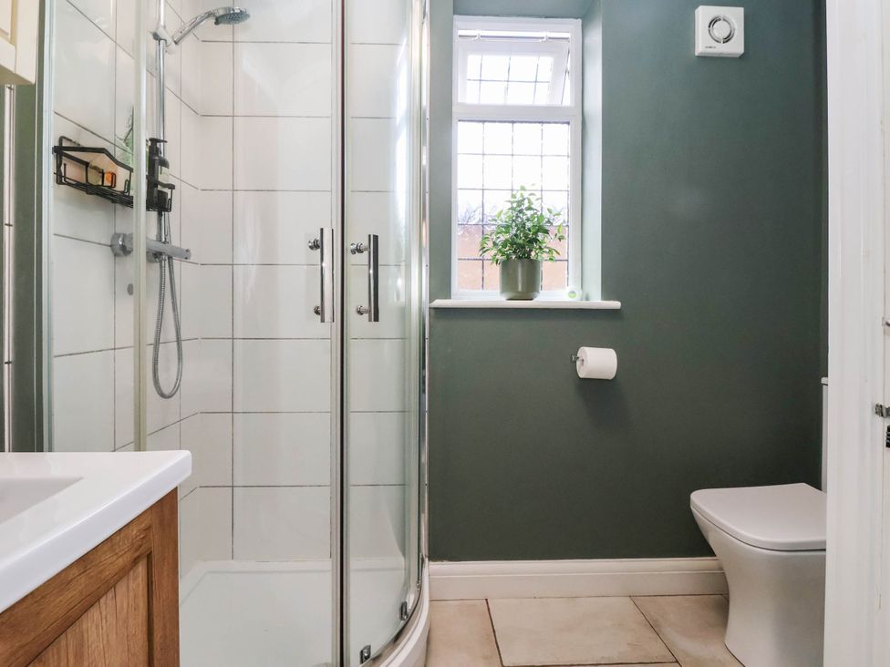 A bathroom with a shower and toilet at The Snug in 