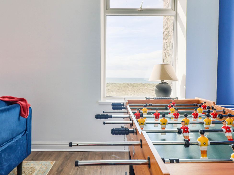 A game room with a foosball table and a sofa at Flat 4 Greenfields Barmouth