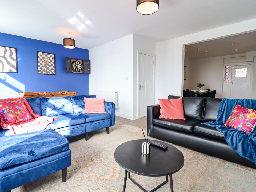 A living room with a sofa and coffee table at Flat 4 Greenfields Barmouth
