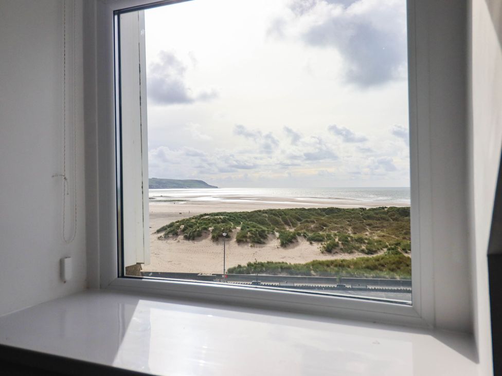 A view from a window showing beach and sea at Flat 4 Greenfields Barmouth