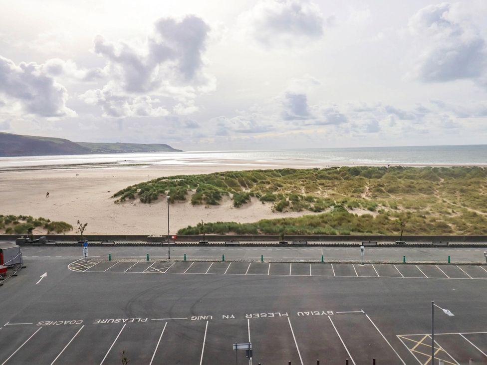 A beach with sand dunes and an ocean view at Flat 4 Greenfields Barmouth