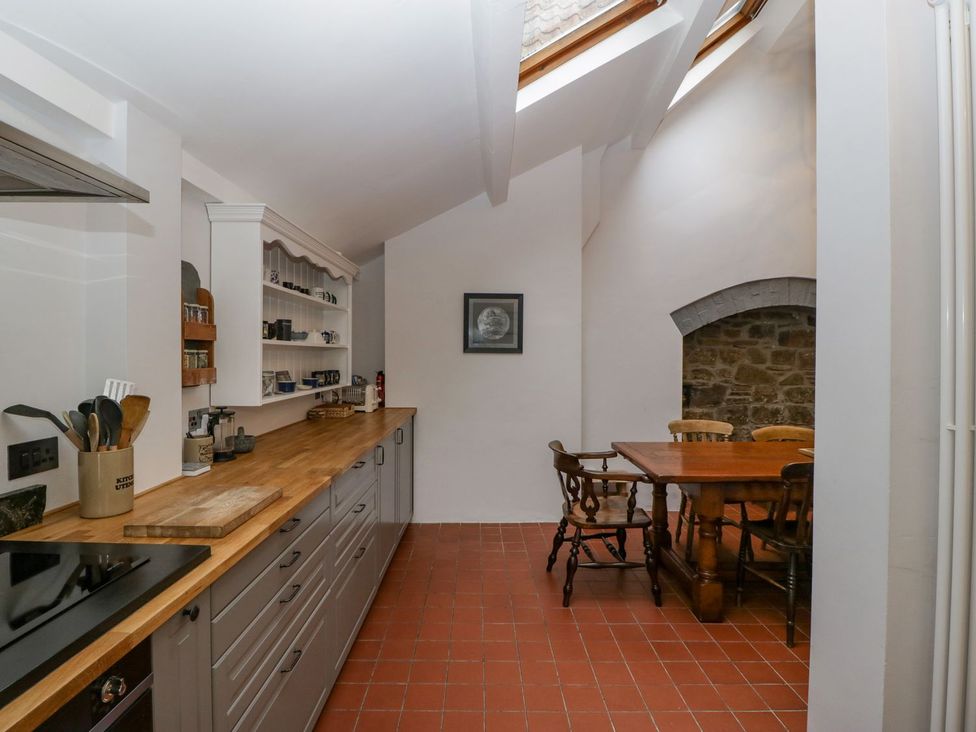 A kitchen with a table and chairs at Kylemore in Glastonbury