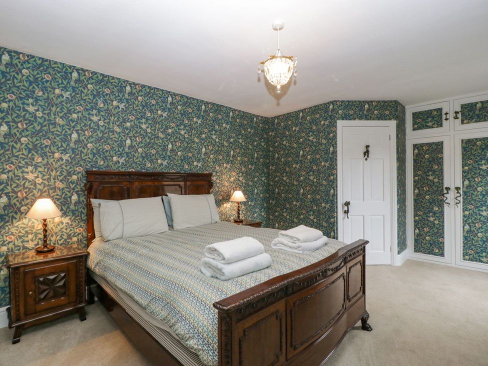A bedroom with a bed and lamp at Kylemore in Glastonbury