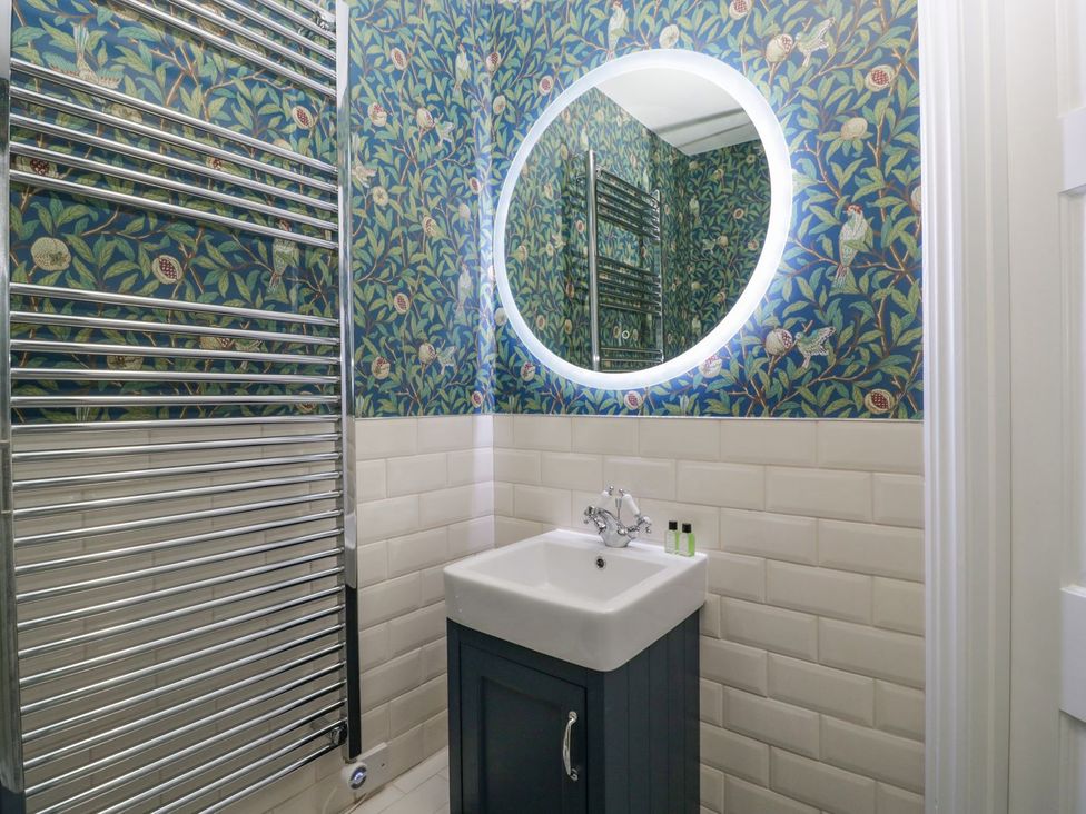 A bathroom with a wash basin and towel rail at Kylemore in Glastonbury