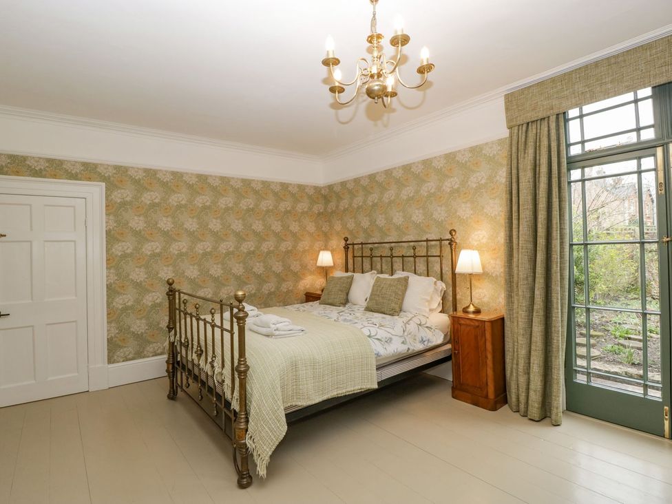 A bedroom with a bed and window at Kylemore in Glastonbury