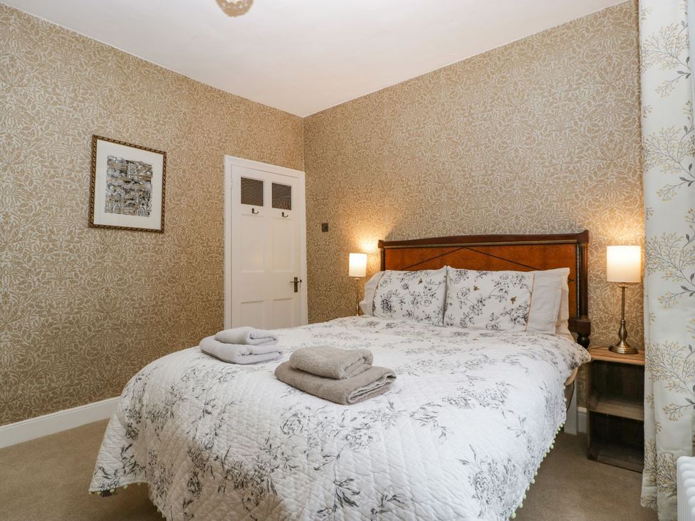 A bedroom with a bed and bedside table at Kylemore in Glastonbury