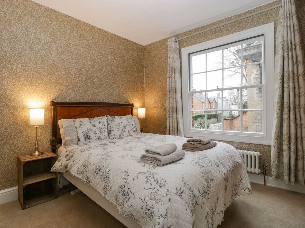 A bedroom with a bed and bedside table at Kylemore in Glastonbury