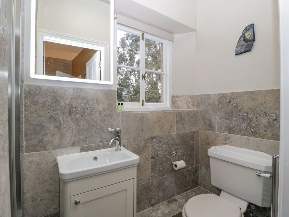 A bathroom with a sink and toilet at Kylemore in Glastonbury