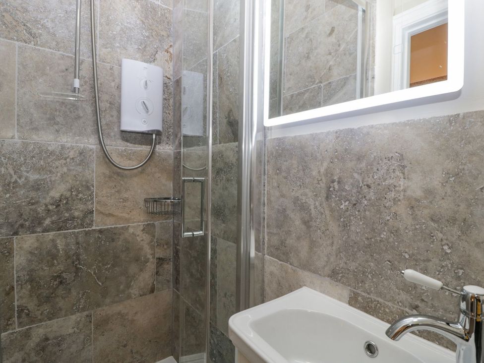 A bathroom with a shower and sink at Kylemore in Glastonbury