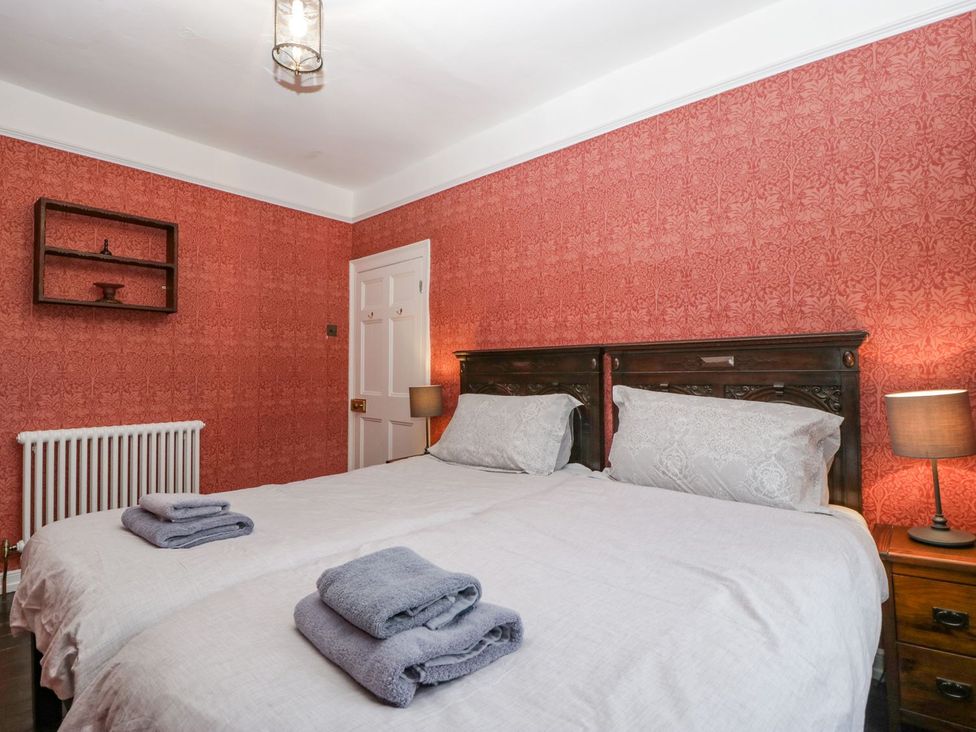 A bedroom with a double bed and nightstand at Kylemore in Glastonbury