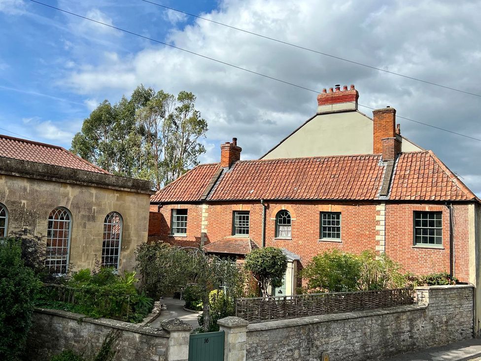 A house with green windows and brick walls at Kylemore in Glastonbury