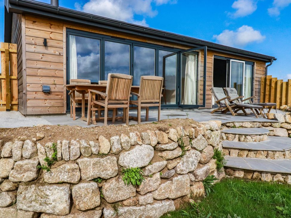An outdoor area with a wooden dining set and stone steps at Granfer’s