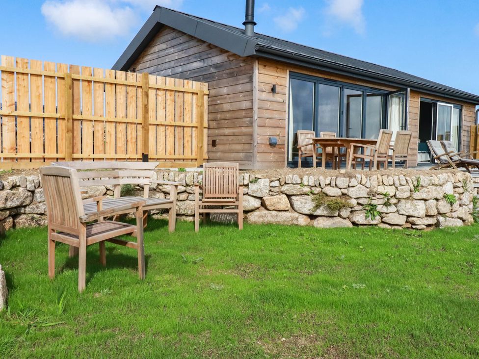 An outdoor seating area with chairs and a table at Granfer’s