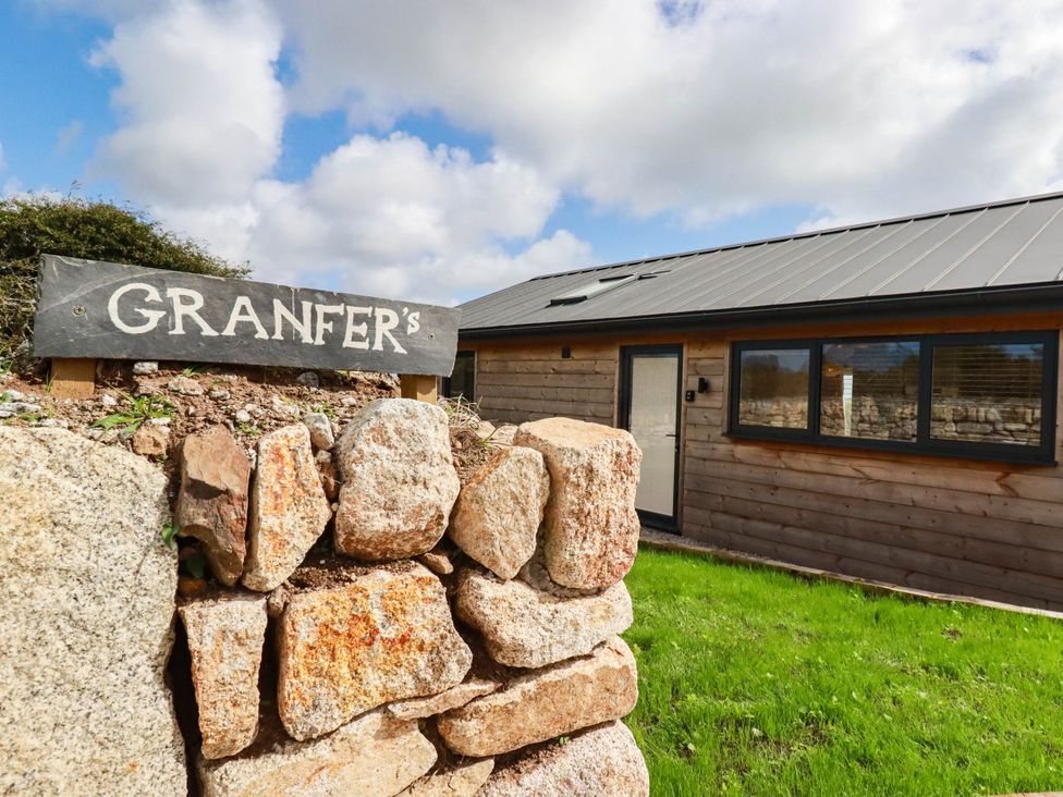 A sign with Granfer's and a stone wall at Granfer’s