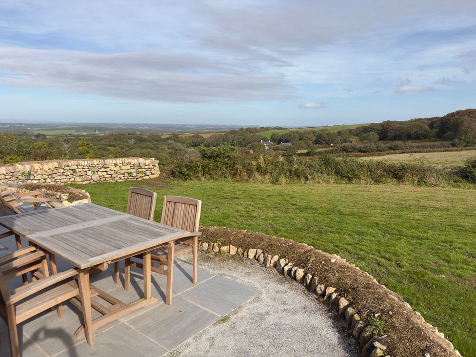 An outdoor dining area with a table and chairs at Granfer’s near Penryn