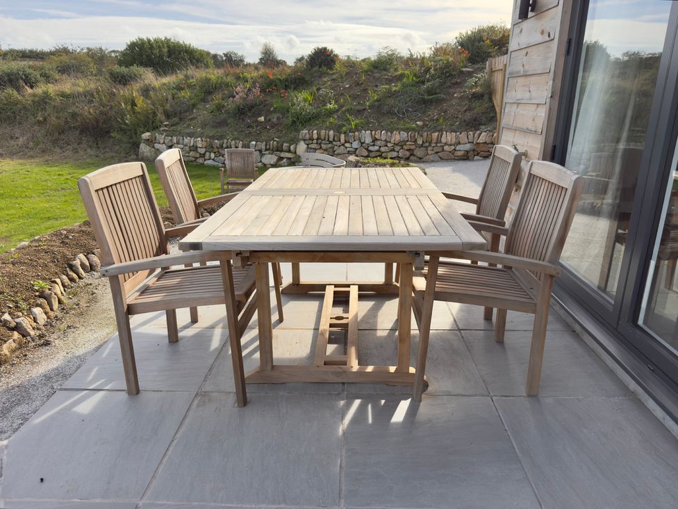 A patio with a table and chairs at Granfer’s near Penryn