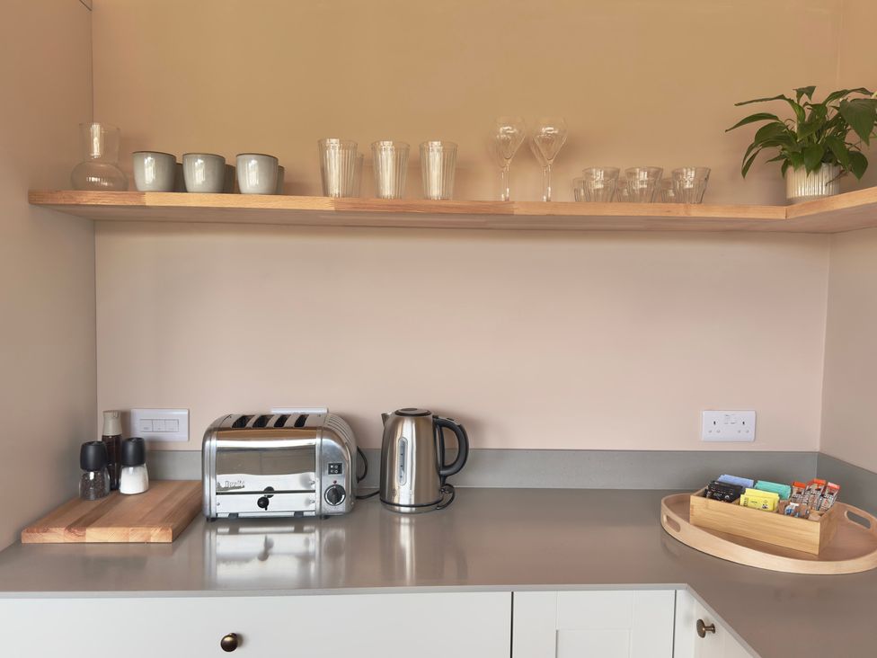 A kitchen countertop with a toaster kettle and cups at Granfer’s near Penryn