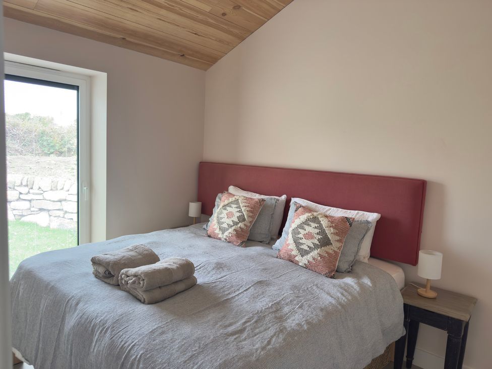 A bedroom with a bed and towels at Granfer’s near Penryn