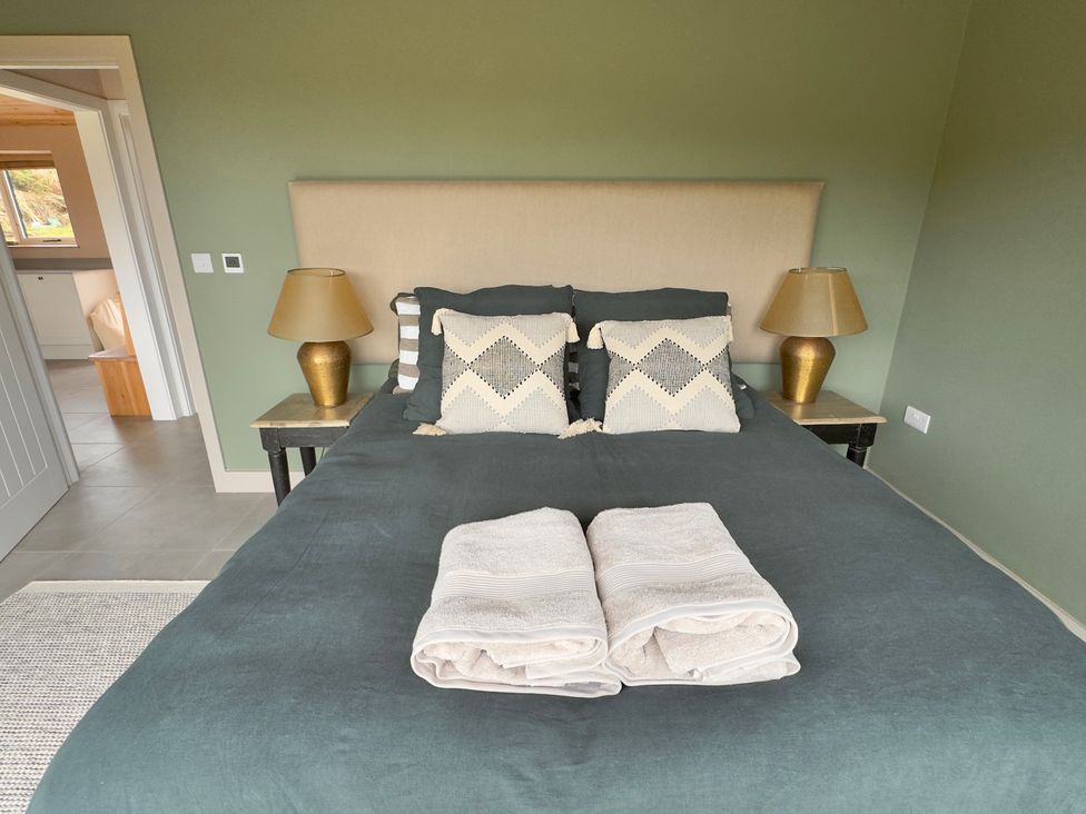 A bedroom with a bed and lamps at Granfer’s near Penryn