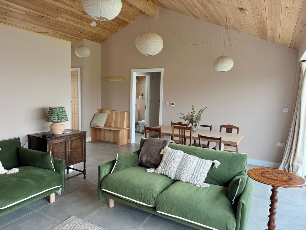 A living room with two sofas and a dining table at Granfer’s near Penryn