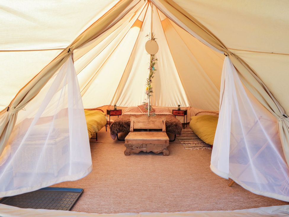 A tent with beds and decorative items at Bell Tent in Builth Wells