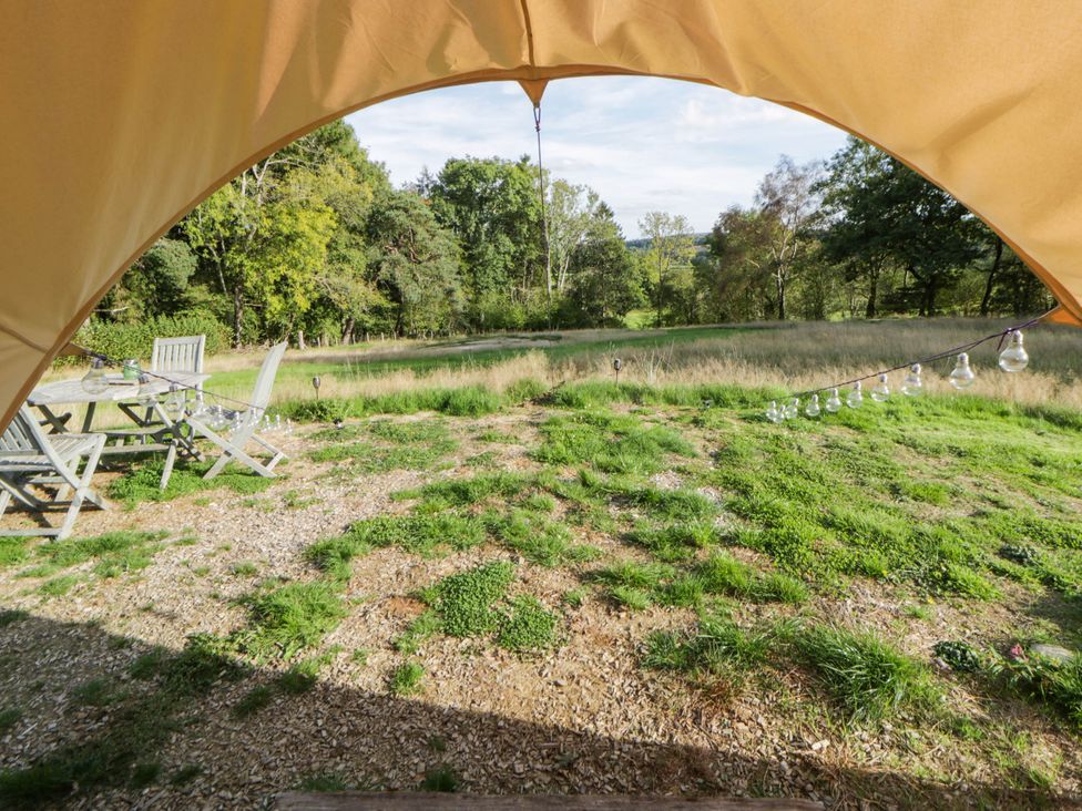 An outdoor area with a table and chairs at Bell Tent in Builth Wells