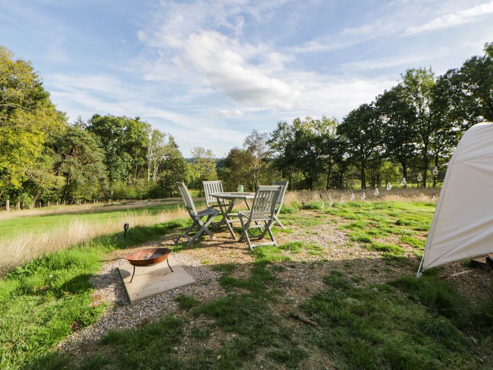 An outdoor area with a table and chairs at Bell Tent Builth Wells