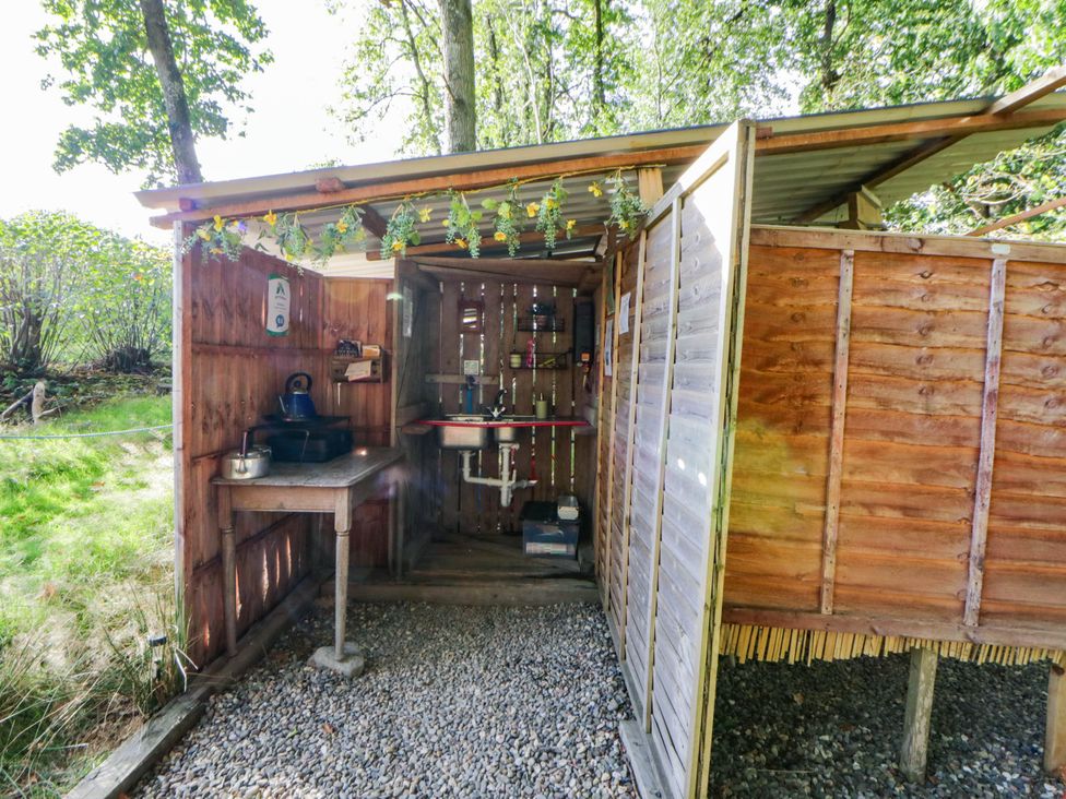 An outdoor kitchen with a sink and counter at Bell Tent in Builth Wells