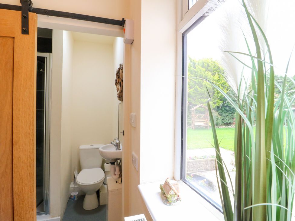 A bathroom with a toilet and sink at Greystones Apartment A near Buxton