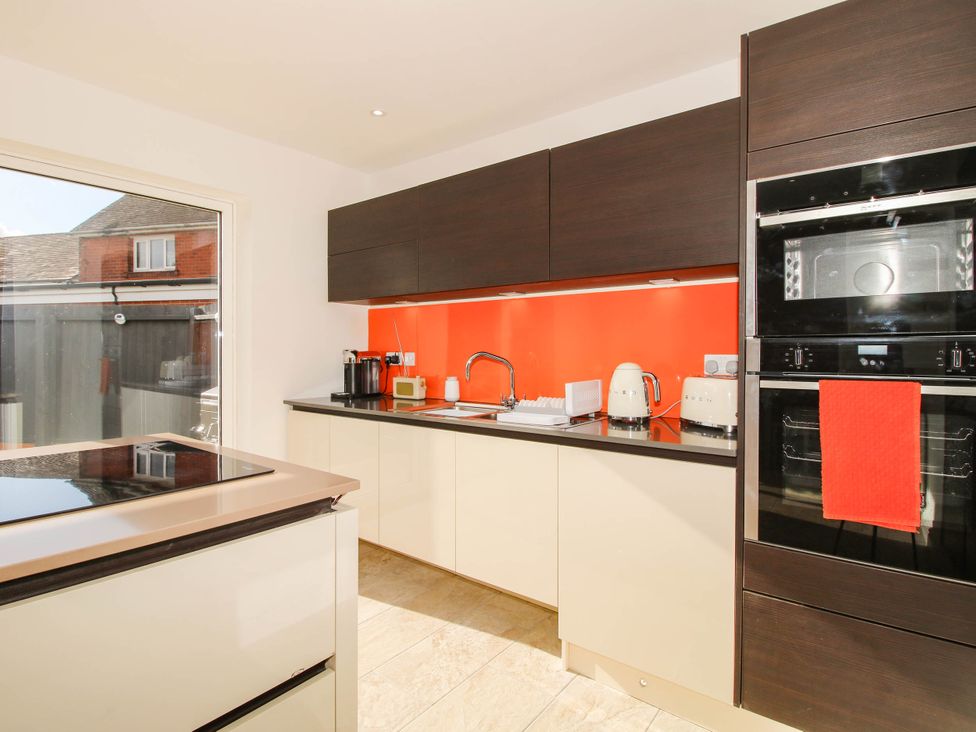 A kitchen with sink, cabinets, and appliances at 3 Jubilee Cottages Pontesbury