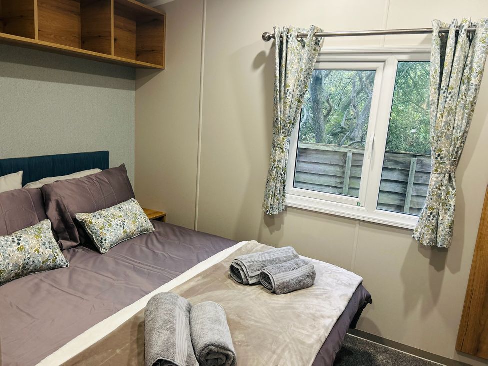 A bedroom with a bed and shelves at Cala Gran - The Retreat 256 Boundary Road Fleetwood
