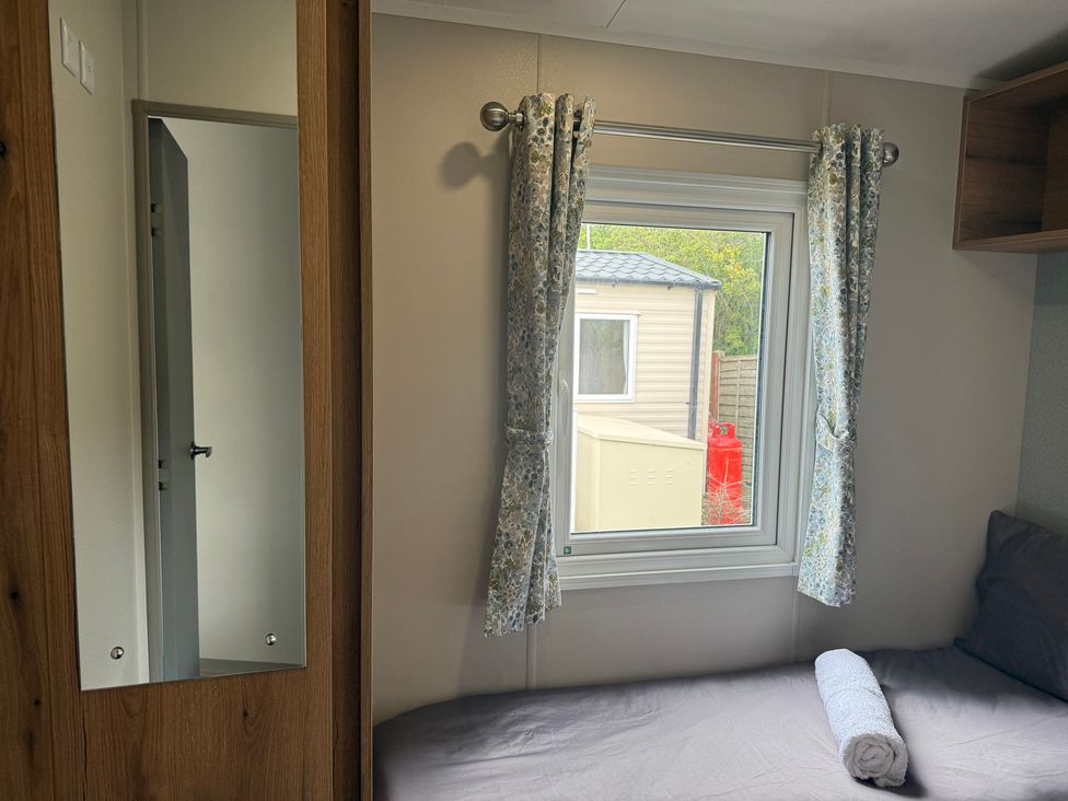 A bedroom with a bed and window at Cala Gran - The Retreat 256 Boundary Road Fleetwood