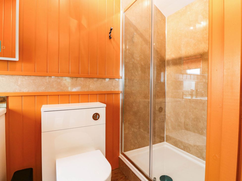 A bathroom with a shower and toilet at Calendonia Hut West Mains near Haggerston