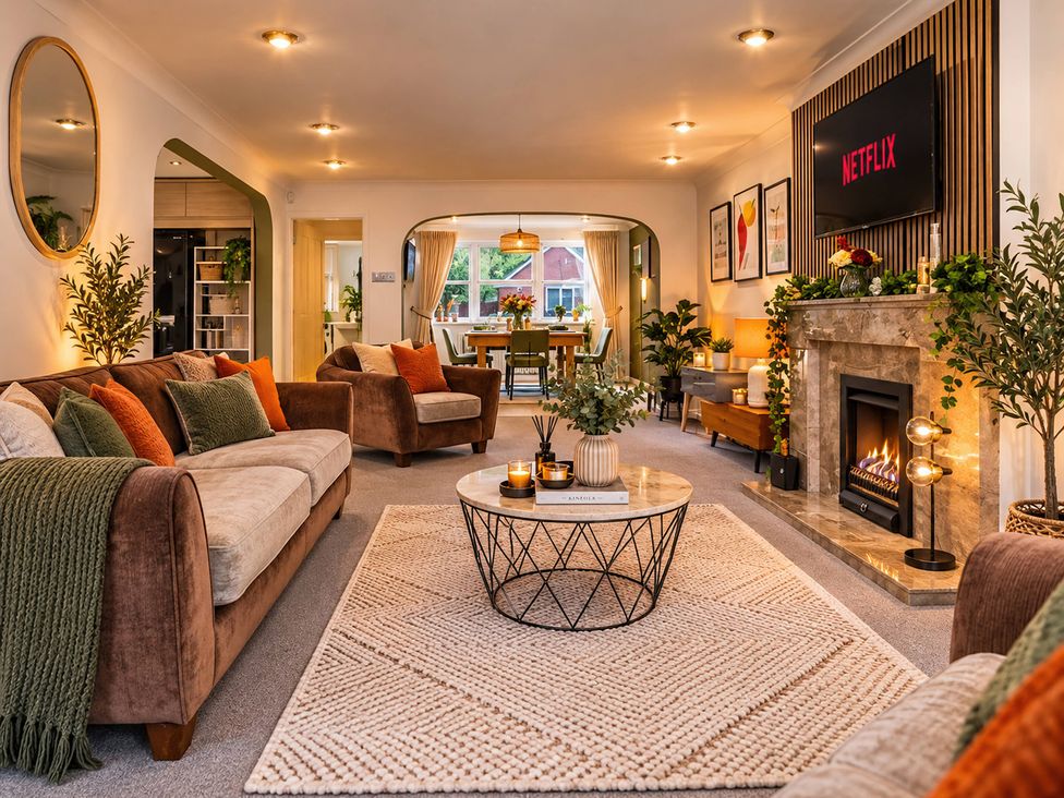 A living room with a fireplace and coffee table at 20A Westend Parade in Gloucester