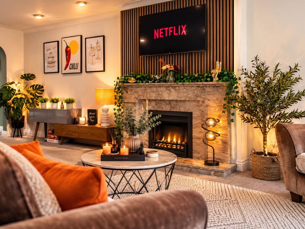 A living room with a fireplace and a television at 20A Westend Parade in Gloucester