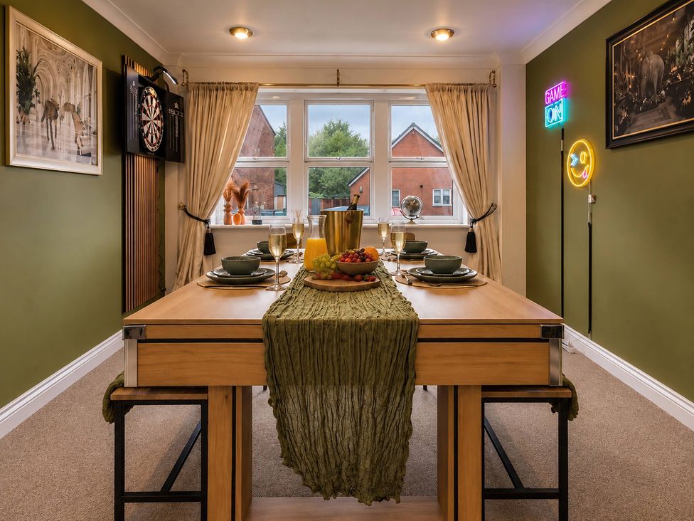 A dining room with a table set for dinner at 20A Westend Parade, Gloucester
