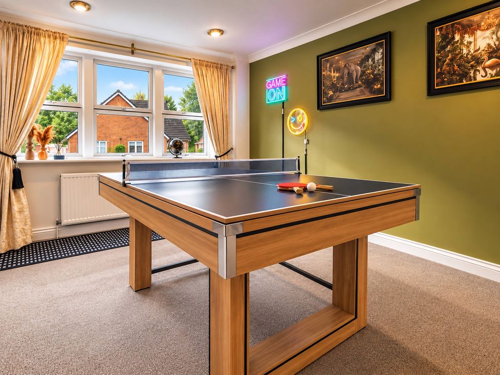 A game room with a ping pong table at 20A Westend Parade in Gloucester