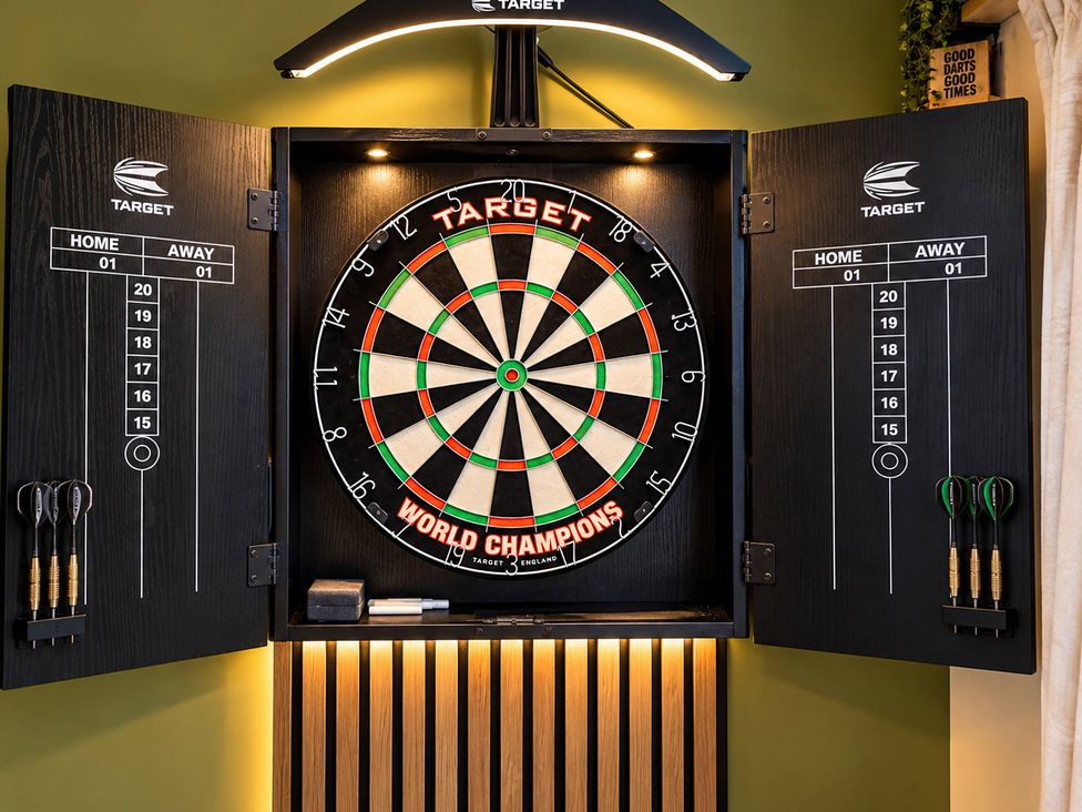 A dartboard and scoring board in a game room at 20A Westend Parade, Gloucester