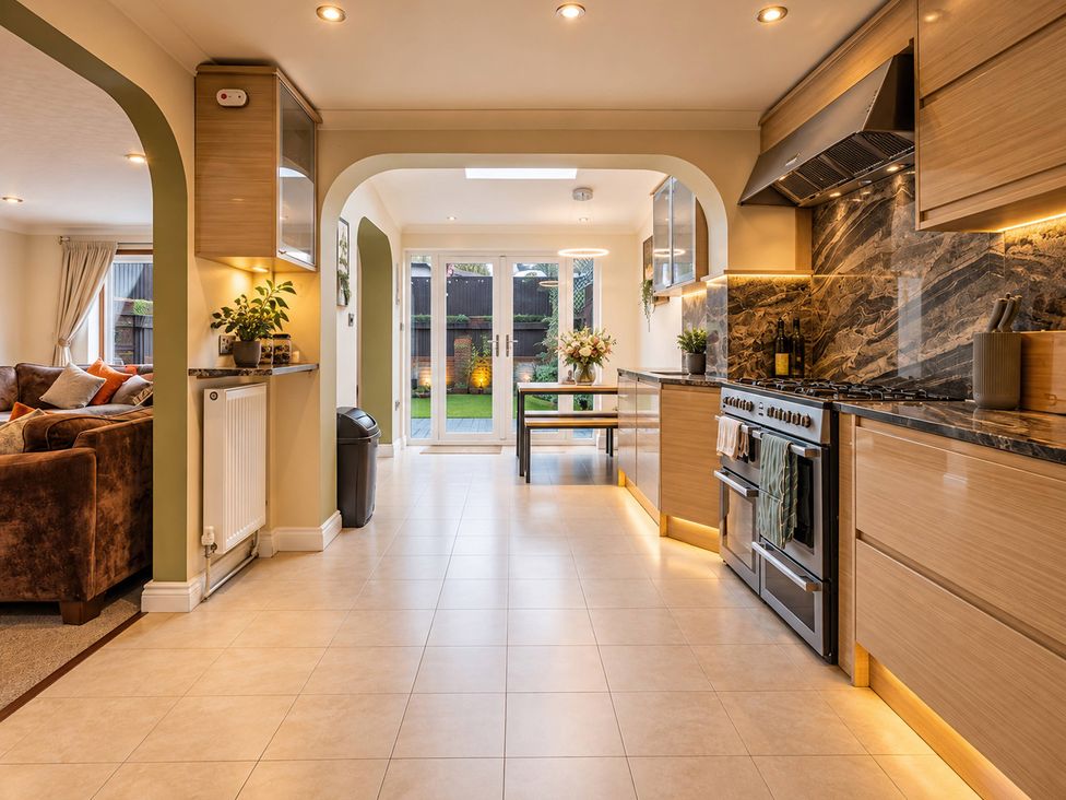 A kitchen with a cooker and a table at 20A Westend Parade, Gloucester