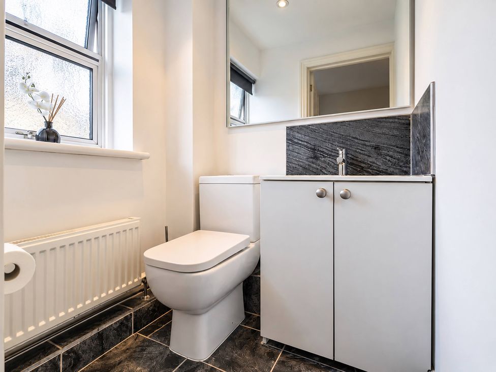 A bathroom with a toilet and sink at 20A Westend Parade in Gloucester