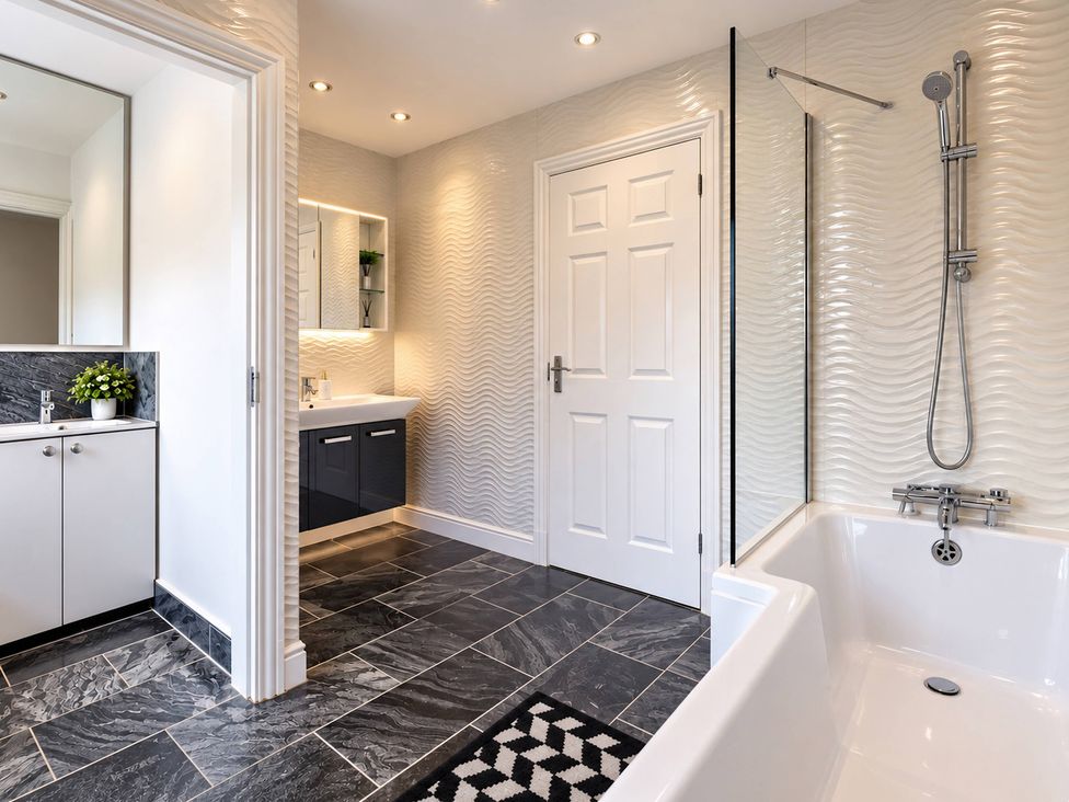 A bathroom with a bathtub and sink at 20A Westend Parade in Gloucester