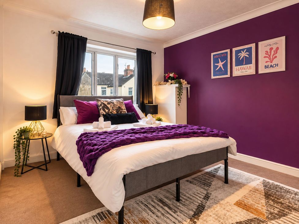 A bedroom with a bed and decorative items at 20A Westend Parade in Gloucester