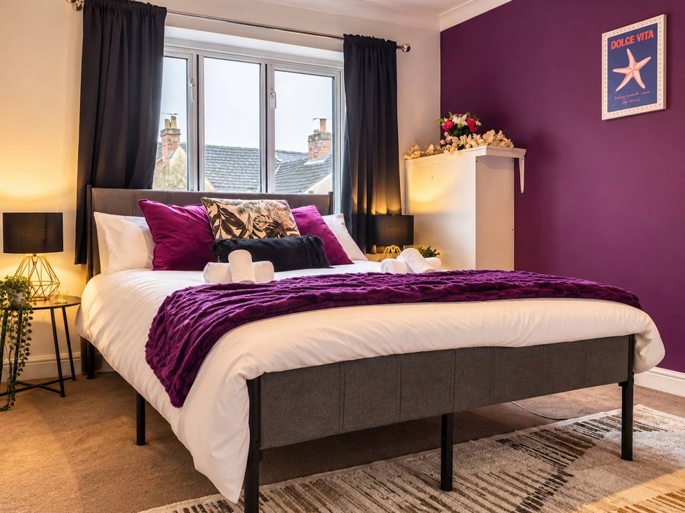 A bedroom with a bed and decorative items at 20A Westend Parade in Gloucester