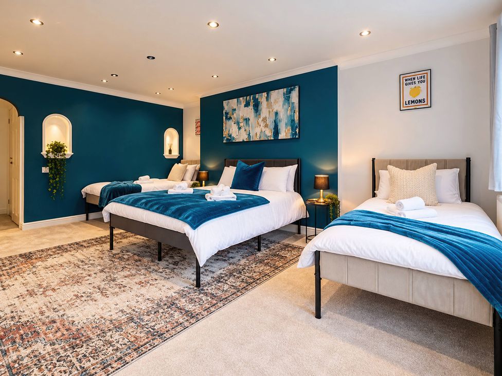 A bedroom with multiple beds and decorative elements at 20A Westend Parade in Gloucester